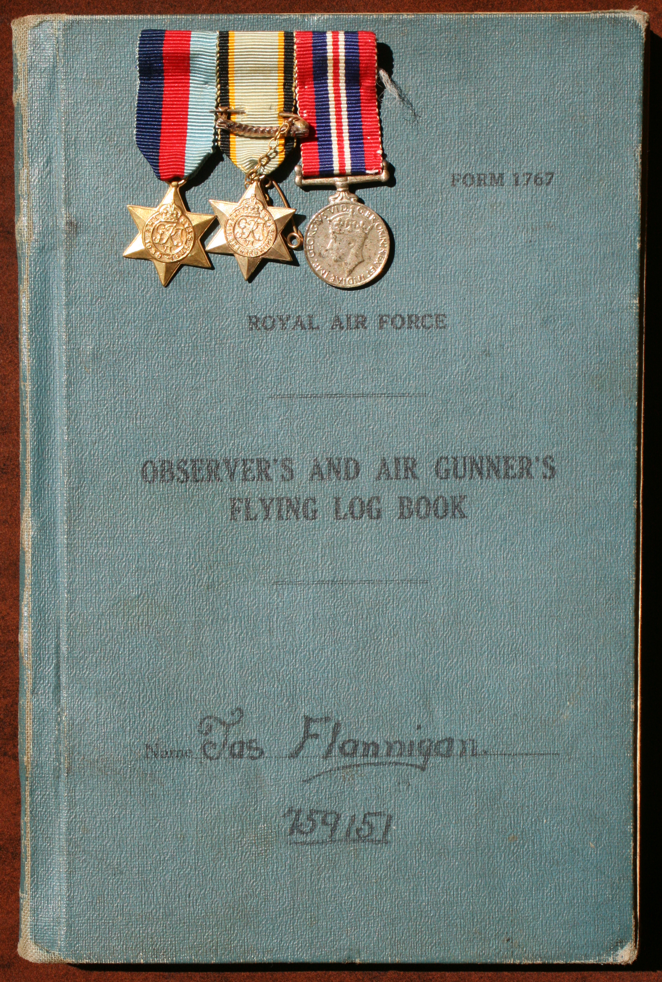 James Flannigan's flying log book, with his service medals