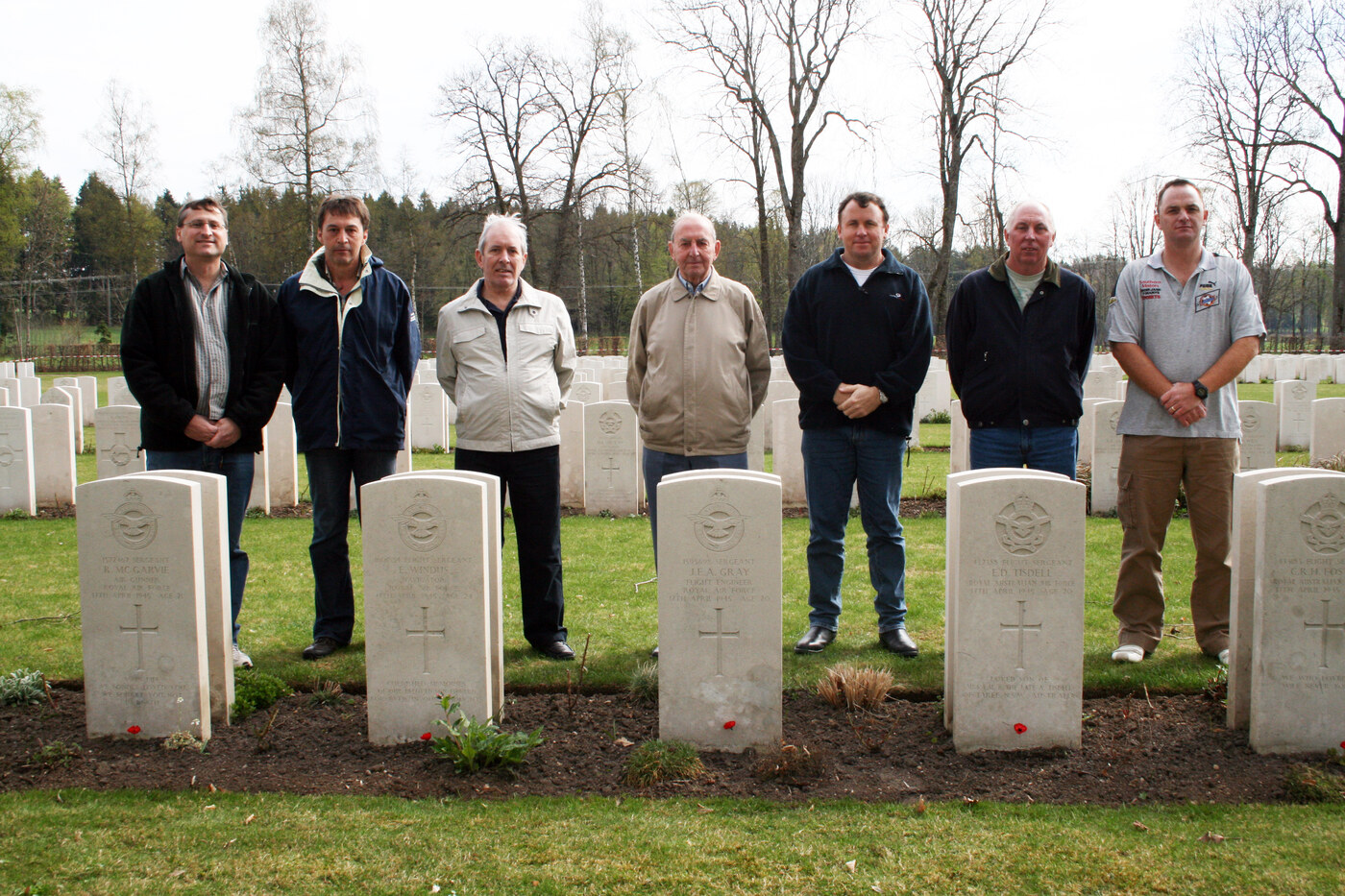 Darren May, Rolf Ebnet, John Watts, Joe Hollins, Greg Weir, John Colls and Craig Rowlands at the graves of the MZ-467 crew